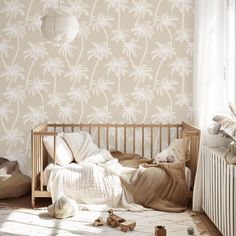 a bedroom with a bed and wallpaper that has white palm trees on the wall