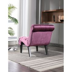 a purple chair sitting on top of a rug