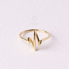 The 14K Gold Heartbeat Ring is a beautiful and unique piece of jewelry that is perfect for any special occasion. This Love Forever Ring features a lifeline pulse design, with a minimalist heartbeat motif that symbolizes the eternal bond of love. This Lifeline Pulse Band Ring is made of 14K gold, making it a high-quality and durable choice for a special gift. This Heartbeat Gold Ring would make a wonderful gift for Christmas, Father's Day, Mother's Day, Valentine's Day, an anniversary, or a birth Modern 14k Gold Heart Ring For Wedding, Heartbeat Ring, Heart Beat Ring, Forever Ring, Forever Rings, Gold Armband, Gold Anklet, Love Forever, Ring Minimalist