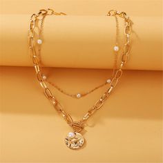 Top off your everyday ensembles with this gleaming 18k gold-plated necklace flaunting a Figaro-style chain and pearl pieces for iridescent accessorizing. Chain 1 : 15.55" L with 2.95" extender Chain 2 : 20.87" L Lobster claw clasp 18k gold-plated copper / pearl Alloy Pearl Chain Necklace For Gift, Pearl Chain Necklace In Alloy As Gift, Trendy Gold Necklace With Pearl Charm, Gold Alloy Jewelry With Pearl Charm, Gold Delicate Chain Layered Necklace With Pearls, Trendy Gold Pearl Chain Necklace, Gold Pearl Chain Necklace With Adjustable Chain, Elegant Gold Layered Necklace With Pearl Charm, Pearl Chain Layered Necklace As A Gift