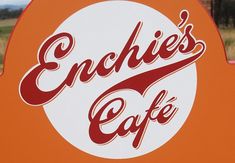 an orange sign with the words enchies cafe written in red and white on it