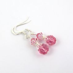 These beautiful pink earrings are created with rose pink Swarovski crystal element beads and beautiful silver bead caps. The earrings are composed of silver plated components. These pink drop crystal earrings are lightweight and great for anyone who loves pink. They come in a cute organza bag. See the matching necklace via the link below. LENGTH: about 1 & 1/2 inches total (top of ear wire to end of lowest bead) Matching pink bead necklace: https://www.etsy.com/listing/201854945/pink-necklac Handmade Pink Crystal Earrings In Sterling Silver, Elegant Pink Earrings With Faceted Beads, Handmade Pink Crystal Sterling Silver Earrings, Pink Crystal Ear Wire Earrings For Gift, Elegant Pink Beaded Earrings With Faceted Beads, Pink Sterling Silver Crystal Earrings As Gift, Elegant Pink Beaded Sterling Silver Earrings, Pink Dangle Crystal Earrings With Faceted Beads, Handmade Pink Crystal Earrings