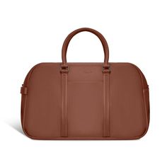 This Champs leather duffle bag from the Onyx Collection is the perfect travel accessory for a weekend get-away. Features removable and adjustable shoulder straps, easy carry top handles, a trolley strap with back zipper pocket, and an inner RFID zipper pocket for extra security. The convenient side carry handle and the purse feet allow you to put down your bag without fear of damage. Dimensions: 20 in. x 12.5 in. Color: Brown. Modern Brown Duffle Bag For Travel, Brown Travel Bag With Top Carry Handle, Travel Duffle Bag Satchel With Top Carry Handle, Rectangular Travel Duffle Bag With Top Carry Handle, Classic Large Capacity Satchel For Travel, Versatile Brown Travel Bag For Weekend Trips, Versatile Brown Travel Bag, Weekender Shoulder Bag With Adjustable Strap For Overnight Trips, Versatile Brown Weekender Bag For Travel