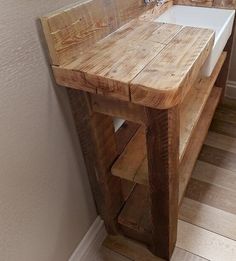 a bathroom sink made out of wooden planks