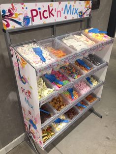 a display case filled with lots of cupcakes and cake mix on it's sides