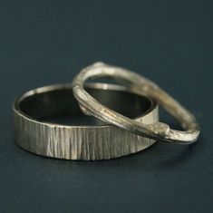 two silver rings sitting on top of each other