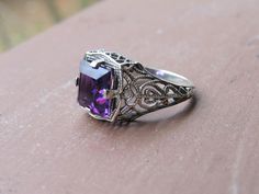 Vintage Sterling Silver Princess cut Amethyst Filigree Ring ...Marked 925...Total of weights 3.4grams...Size 8...Measure of Face 12.9MM...It's in very good condition. Purple Promise Ring With Intricate Design, Purple Intricate Design Promise Ring, Purple Hallmarked Art Deco Amethyst Ring, Purple Amethyst Ring With Intricate Design, Purple Anniversary Rings With Intricate Design, Art Deco Purple Amethyst Ring, Antique Purple Amethyst Ring With Accent Stones, Formal Purple Amethyst Ring With Filigree, Purple Amethyst Ring With Intricate Design For Promise