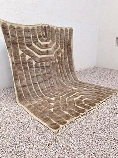 a brown rug sitting on top of a floor next to a wall