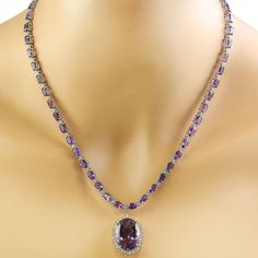 Stamped: 14KTotal Necklace Weight: 29.8 GramsNecklace Length: 18 InchesCenter Amethyst Weight: 15.00 Carat (20.10x15.10 Millimeters)Side Amethyst Weight: 26.00 Carat (6.00x4.00 Millimeters)Diamond Weight: 2.05 Carat (F-G Color, VS2-SI1 Clarity) Face Measures: 24.85x19.40 Millimeter SKU: [600601] Formal Purple Gemstone Necklace, White Gold Amethyst Necklace For Formal Occasions, Luxury Purple Diamond Necklace, Exquisite Amethyst Necklace For Formal Occasions, Formal White Gold Amethyst Necklace, Exquisite Formal Amethyst Necklace, Elegant Purple Multi-stone Necklaces, Luxury Amethyst Necklace For Formal Occasions, Elegant Purple Multi-stone Necklace