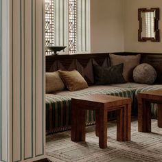 a living room filled with furniture and pillows