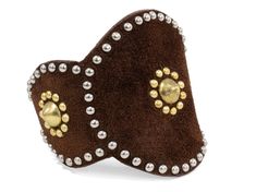 a brown heart shaped brooch with gold and white beads on the side, set against a white background