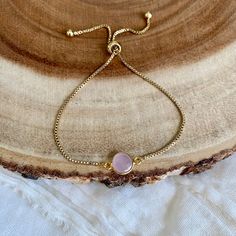 Rose Chalcedony Gold Bracelet / Pink Stone Dainty Adjustable Bracelet / Minimalist Boho Jewelry Minimalist dainty pink gemstone bracelet created with - a gold plated Rose Chalcedony connector - attached to a dainty gold plated brass chain with a slider bead that makes it adjustable - finished off with two gold ball ends Each bracelet is handmade to order and each stone is one of a kind so it may be slightly different than what is pictured. All of my bracelets come packaged in a kraft cotton fill Adjustable Pink Chain Bracelet, Pink Adjustable Charm Bracelet, Elegant Friendship Bracelets With Adjustable Chain, Dainty Pink Bracelets With Adjustable Chain, Pink Dainty Bracelet With Adjustable Chain, Dainty Pink Bracelet With Adjustable Chain, Delicate Adjustable Pink Bracelet, Adjustable Rose Gold Round Crystal Bracelet, Adjustable Round Rose Gold Crystal Bracelet