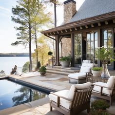 an outdoor living area with chairs and a pool