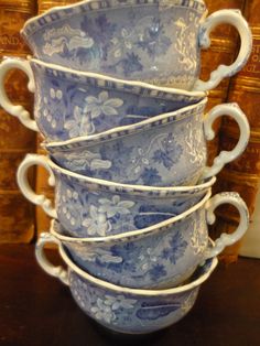 a stack of blue and white cups sitting on top of a table