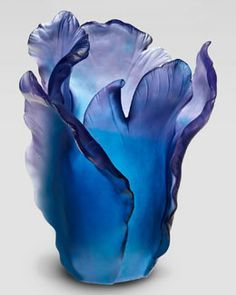 a blue flower that is in the shape of a large flower with long, thin petals