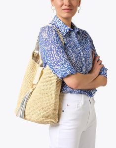 This beige raffia bag from Laggo is the perfect summer beach bag. Large enough to carry all of your essentials, this shoulder bag features a tassel and a braided leather handle. Pair this bag with a pair of jeans and a light top for a hot summer day. Beige Crochet Bag With Tassels For Travel, Beige Tassel Bucket Bag For Vacation, Beige Tassel Bucket Bag For Daily Use, Beige Bucket Bag With Tassels For Daily Use, Beige Crochet Bag With Woven Leather, Beige Woven Leather Beach Bag For Everyday, Everyday Beige Woven Leather Beach Bag, Sand-colored Tote Shoulder Bag With Braided Handles, Beige Straw Bag With Tassels For Travel