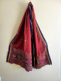 Gorgeous and earthy hand woven khun dupatta in reddish maroon color with exclusively hand embroidered lambani embroidery, mirror embellishments all over.  Can use it as a stole, shawl or dupatta. Lambani Embroidery, Embroidery Dupatta, Embroidery Mirror, Maroon Color, Scarf Wrap, Hand Woven, Hand Embroidered, Scarf Accessory, Shawl