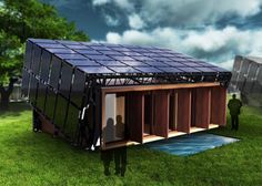 a man is standing in front of a solar powered house on the grass with another person looking at it