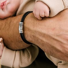 Introducing the perfect gift for any proud dad - our personalized leather bracelet! Handcrafted with premium leather and adorned with sleek silver beads, this bracelet exudes a timeless, masculine charm. Each silver bead is intricately engraved with the names of your beloved kids, creating a heartfelt and meaningful keepsake. With its adjustable clasp, this bracelet ensures a comfortable fit for every wrist size. Showcasing the love and bond between a father and his children, this personalized l Classic Leather Bracelet For Gift, Father's Day Black Leather Jewelry, Classic Leather And Stainless Steel Bracelet For Gift, Personalized Black Leather Bracelet For Father's Day, Modern Everyday Wristband For Father's Day, Modern Wristband For Everyday And Father's Day, Leather Braided Bracelets With Stainless Steel Clasp, Everyday Silver Leather Braided Bracelet, Leather Bracelets For Father's Day