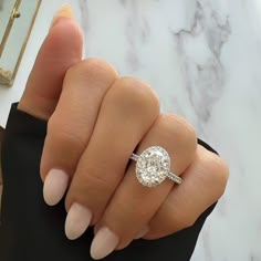 a woman's hand with a diamond ring on it