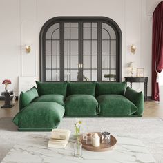 a living room with a large green couch in the middle and a coffee table on the other side