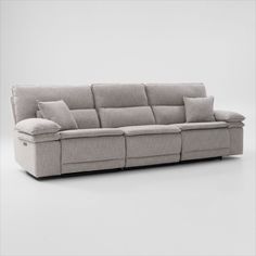 the reclining sofa with pillows is shown in front of a white wall and floor