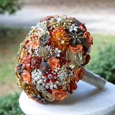 a bridal bouquet with orange and gold flowers