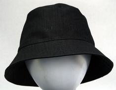 a white mannequin head wearing a black hat