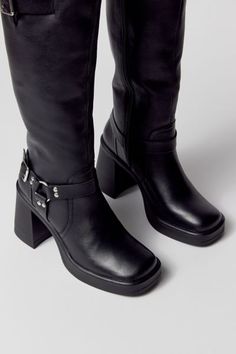 Motorcycle boots from Steve Madden. Tall silhouette in premium leather topped with minimalist moto detailing. Squared toe with a high block heel. Features Steve Madden moto boots Soft leather with moto detailing Zip closure Content + Care Leather, rubber Spot clean Imported Size + Fit Shaft: 13.75" h; 14" circ Heel: 3.5" h | Steve Madden Francine Moto Boot in Black, Women's at Urban Outfitters Modern Leather Platform Boots With Stacked Heel, Modern Leather Knee-high Boots With Block Heel, Edgy Boots With Stacked Heel For Workwear, Modern Leather Platform Boots With Block Heel, Edgy Stacked Heel Boots For Workwear, Edgy Medium Width Heeled Boots For Workwear, Leather Knee-high Platform Moto Boots, Knee-high Leather Platform Moto Boots, Chic Moto Boots With Stacked Heel And Square Toe