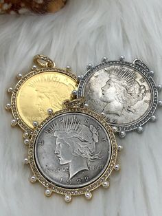 NOTE: ALL USA REPLICA COINS ARE STAMPED COPY ON THE BACK OF THE COIN. IT IS AGAINST THE LAW TO REPRODUCE A USA COIN WITHOUT STAMPING IT AS A COPY. Reproduction coin 50mm Coin Bezel w/Pearls and CZ Material: bezel is made of Cast Zinc Alloy, coin is made of brass, gold coins are brass and gold plated Measure - Bezel = 50mm Coin = 38mm Bale = ID 7.28mm Bale = OD11.43mm 3 bezel Styles (Choose from menu) Please reference picture for exact colors of coins and bezels. Bead chain is not included with t Peace Dollar, Coin Design, Bohemian Jewellery, Coin Bracelet, Coin Pearls, Dollar Coin, Old Coins, Gold Coin, Brass Charms