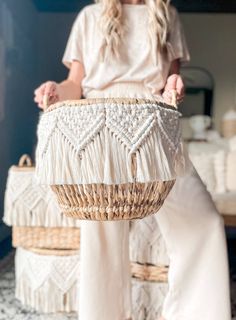 a woman holding a woven basket in her hands