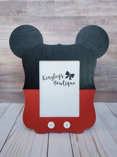 a mickey mouse frame with the word disney's boutique on it and a bow at the top