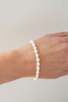 Our Freshwater Pearl Bracelet is made with real freshwater pearls and gold filled jump rings and closure. This timeless bracelet pairs well with stackable bracelets or as a stand alone piece! Pearls are always classic, and you'll love this piece! Adjustable Classic Pearl Bracelet For Everyday, Classic Adjustable Pearl Bracelet, Classic Adjustable Hypoallergenic Pearl Bracelet, Classic Everyday Beaded Bracelets With Pearl Charm, Elegant Everyday Pearl Stretch Bracelet, Everyday Pearl Bracelets With Pearl Drop, Classic Everyday Pearl Bracelet With Pearl Charm, Classic Adjustable Pearl Drop Bracelet, Classic Everyday Pearl Chain Bracelets