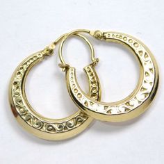 Super nice little old 14K gold hoop earrings with a fancy scrolling engraved and embossed pattern. They measure ¾ inch wide by ⅞ inch tall marked 14K. They weigh 1.5 grams. The condition is very good. Vintage 14k Gold Earrings With Intricate Design, Engraved 14k Yellow Gold Hoop Earrings, Antique Gold Engraved Earrings, Vintage Round Hoop Earrings With Intricate Design, Victorian Engraved Yellow Gold Earrings, Elegant Etched Round Earrings, Victorian Style Engraved Yellow Gold Earrings, Yellow Gold Brass Hoop Earrings With Intricate Design, Traditional Engraved Round Earrings