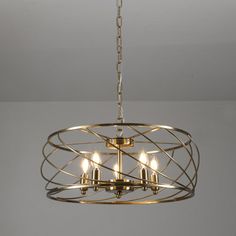 a chandelier with five lights hanging from it's center circle, in an empty room