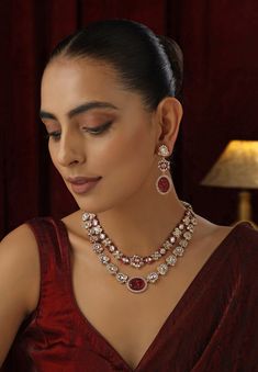 Elevate your style with this Red Polki Layered Necklace set, featuring vibrant red stones intricately set in traditional Polki design and enhanced with a stunning rose gold finish. The multi-layered arrangement adds depth and sophistication, while the warm rose gold accents beautifully complement the rich red hues. Perfect for weddings, or any special occasion, this necklace set exudes timeless elegance and contemporary charm. Polki Necklace, Rose Gold Accents, Layered Necklace Set, Red Stone, Vibrant Red, Gold Finish, Layered Necklaces, Necklace Set, Timeless Elegance