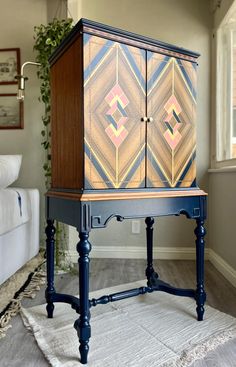 a blue cabinet sitting on top of a rug in a living room