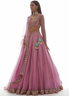 Step into elegance with our Muted Pink Applique Organza Lehenga Set. This exquisite ensemble features a stunning muted pink Mughal bootis applique v neck blouse, complemented by a flowing organza dupatta. The skirt and dupatta is adorned with a delicate mirror border, adding a touch of glamour to this traditional attire. Crafted with attention to detail, this lehenga set is perfect for weddings, festive occasions, or any special event. Embrace timeless beauty and make a statement with Vani's Muted Pink Applique Organza Lehenga Set. Composition : Lehenga and Dupatta - Organza, Blouse - Georgette, Lining - Silk Blend Care: Dry Clean Only and Vacuum Storage This product can be customized for sleeves, length of blouse and neckline Delivery : 6-8 weeks as the product is hand crafted. Check Size Vani Vats, Applique Blouse, Lehenga Dupatta, Light Pink Blouses, Organza Lehenga, Indian Outfits Lehenga, Lehnga Dress, Organza Blouse, Lehenga Skirt