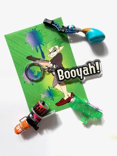 a keychain with the word booyah on it and some paint splatters