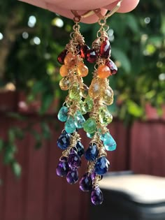 "🌈 💎 A lovely cascade of faceted teardrop gemstones! These are made up of genuine Mozambique and Mandarin garnets, citrine, peridot, sky-blue apatite, kyanite and African amethysts. Wrapped in 14K gold-filled wire, and suspended beneath gold-filled leverback earwires, these beauties are 2.75\" in length. Lightweight and stunning in the light! Your earrings will be gift-boxed to protect the stones, and gift-wrapping is available upon request. Thanks for checking out my shop!" Rainbow Waterfall, Waterfall Earrings, Purple Quartz, Rainbow Jewelry, Bright Rainbow, Beaded Drop Earrings, Rainbow Earrings, Gold Filled Earrings, Blue Apatite