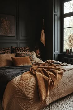 Velvet throws and patterned quilts adding texture to a dark boho bedroom. Rust Black Bedroom, Rich Earthy Aesthetic, Green Brown Bedroom Ideas, Neutral Eclectic Bedroom, Vintage Dark Academia Bedroom, Master Bedrooms Decor Moody, Bedroom Inspirations Master Black Accent Wall, Dark Academia Interior Design Bedroom, Moody Interior Design Bedroom