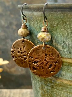 These are my handmade Copper Disc Earrings with earthy toned Czech glass beads. The copper metal discs are domed and have texture, with a very earthy tribal aesthetic, a bit Boho chic style. A great pair of everyday earrings! The ear-wires are hypoallergenic niobium wire, safer for sensitive ears. I create each piece of metal by hand, my jewelry is earthy, rustic, and organic with intentional artistic imperfections. No two pieces are exactly alike, creating truly one of a kind jewelry. ❤SIZE *7/ Bohemian Brown Beaded Round Earrings, Adjustable Earthy Dangle Earrings, Artisan Brown Beaded Nickel-free Earrings, Handmade Vintage Copper Beaded Earrings, Adjustable Earthy Beaded Earrings As Gift, Bohemian Bronze Earrings With Round Beads, Earthy Beaded Dangle Earrings As Gift, Bohemian Brown Beaded Nickel-free Earrings, Brown Bohemian Earrings With Round Beads