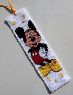 a cross stitch bookmark with a mickey mouse on it's face and stars in the background