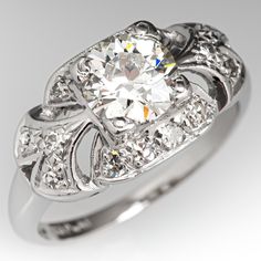 This gorgeous circa 1930s ring is centered with a four-prong set round old European cut diamond weighing 0.85 carat. The ring features a pierced gallery milgrain edging and is accented with fourteen (14), bead set, round single brilliant cut diamonds. The ring measures 9.3 mm wide at the top, rises 6.0 mm above the finger, tapering to 1.7 mm wide and 1.2 mm thick at the base of the shank. This ring is currently a size 4.75. Vintage Diamond Rings With Center Stone, Vintage Brilliant Cut Diamond Ring, Vintage Diamond Ring With Brilliant Cut, Vintage Rings With Center Stone And Round Cut, Vintage Rings With Round Cut Prong Setting, Vintage Brilliant Cut Round Band Rings, Vintage White Gold Diamond Ring With Round Cut, Vintage Round Cut Diamond White Ring, Vintage Rings With Brilliant Cut Round Band