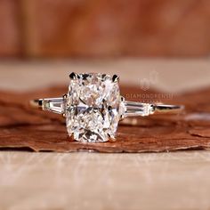 a cushion cut diamond ring with three baguets