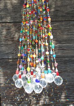 a multicolored chandelier hanging from a wooden wall