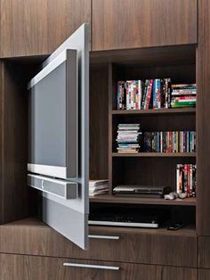 an entertainment center with a flat screen tv on top of it's cabinet doors