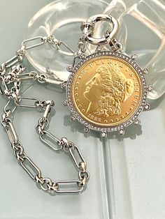 Beautiful reproduction vintage Gold coin pendant, Morgan Peace Dollar coin in a silver bezel with cubic zirconia stones. The bale attached to the coin is also encrusted with CZ stones. The coin is 22k gold plated and elegantly hangs from a multi link Rhodium plated brass chain and a spring lock CZ clasp The spring lock closure not only makes it easy to open and close the necklace for those with difficulty but adds to the creativity of the jewelry piece. Will enhance any outfit. Jeans to the litt Roman Coin Jewelry, Coin Jewellery, Gold Coin Pendant, Chunky Gold Necklaces, Heart Pendent, Jewelry Vendor, Silver Coin Necklace, Gold Snake Chain, Peace Dollar