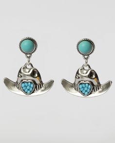 Turquoise bezel post tops with silver cowgirl hat dangles. Tiny blue turquoise beads fill a heart focal on the band of the silver cowboy hat earrings. Go boho beach or traditional western with these, making it your look however they are styled. Dimensions: 1 1/4" long x 1" wide. Content: Zinc Alloy, Iron, Composite Quartz Stone. Silver Cowboy Hat, Cowboy Hat Earrings, Silver Cowgirl, Cowgirl Earrings, Cowgirl Hat, Coastal Cowgirl, Cowgirl Hats, Boho Beach, Cowboy Hat