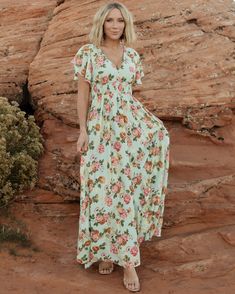 Our Lynlee Metallic Maxi Dress is the epitome of feminine charm🌸 With a deep V-neck that flatters, dainty flutter sleeves, and the cutest floral print, she is the perfect blend of style and grace!✨ Plus, she's totally bump-friendly!😉 Don't miss out on this must-have piece – shop now🛍️ Pink V-neck Dress With Elastic Waistband, Flowy Floral Dress With Smocked Back And Short Sleeves, Green Beach Dress With Elastic Waistband, Pink Maxi Dress With Elastic Waistband For Vacation, Summer Maxi Dress With Flutter Sleeves For Day Out, Spring Flowy Maxi Dress With Elastic Waistband, Casual Ruffle Sleeve Maxi Dress For Garden Party, V-neck Chiffon Dress With Smocked Bodice, Summer Maxi Dress With Flutter Sleeves